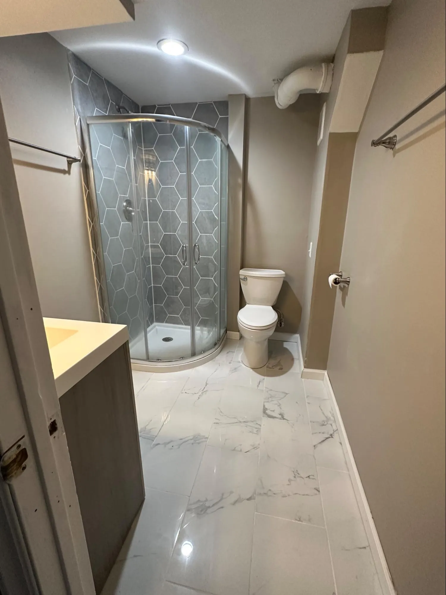 Modern bathroom renovation with full cabinet installation, tile shower enclosure, and updated plumbing fixtures
