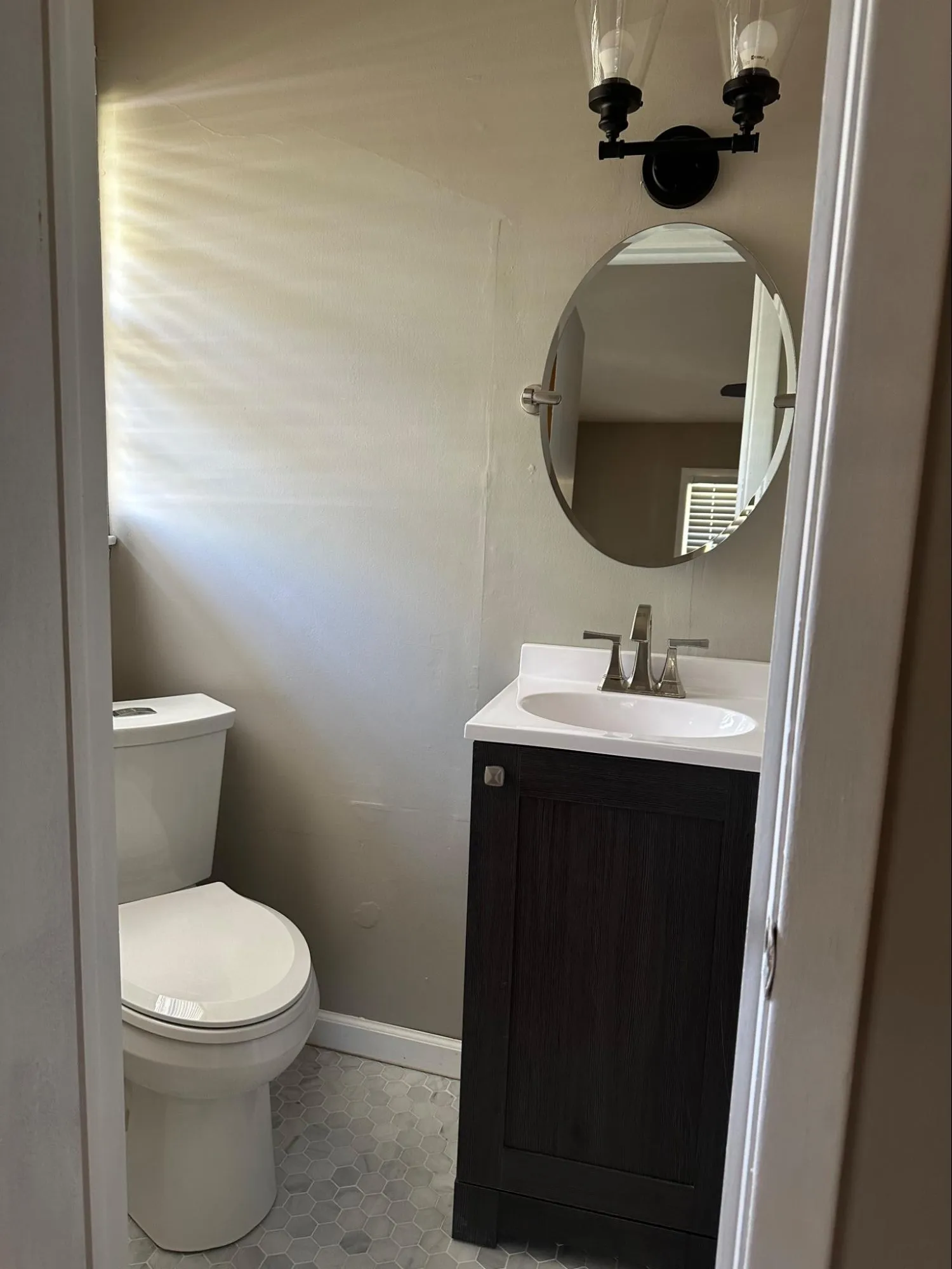Upscale bathroom renovation with custom tile work, refined cabinet craftsmanship, and polished chrome fixtures