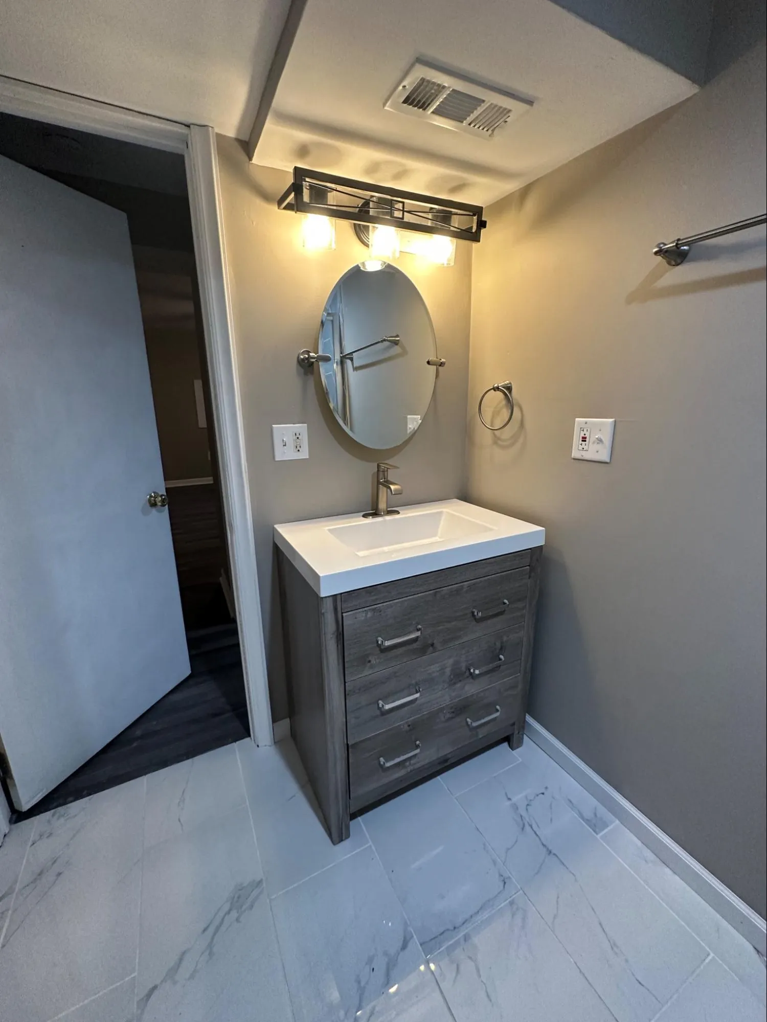 Professional bathroom remodeling with updated plumbing, faucet installation, and tile work completion