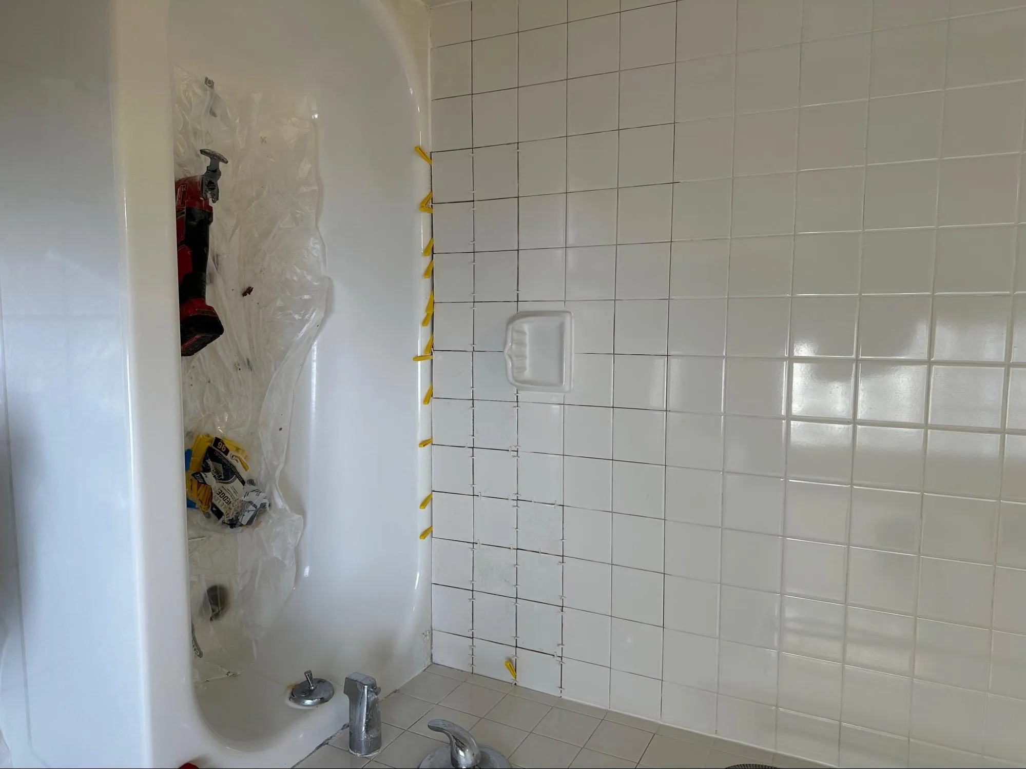 Bathroom before professional renovation with outdated fixtures and worn tile work