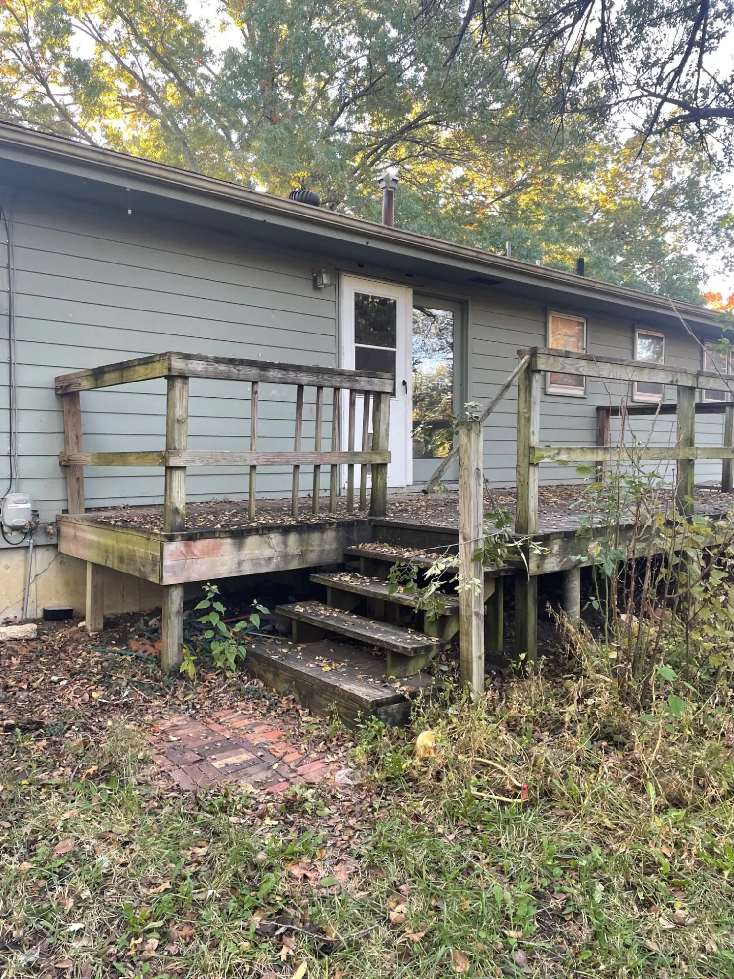 Aged deck before repair showing extensive wood damage