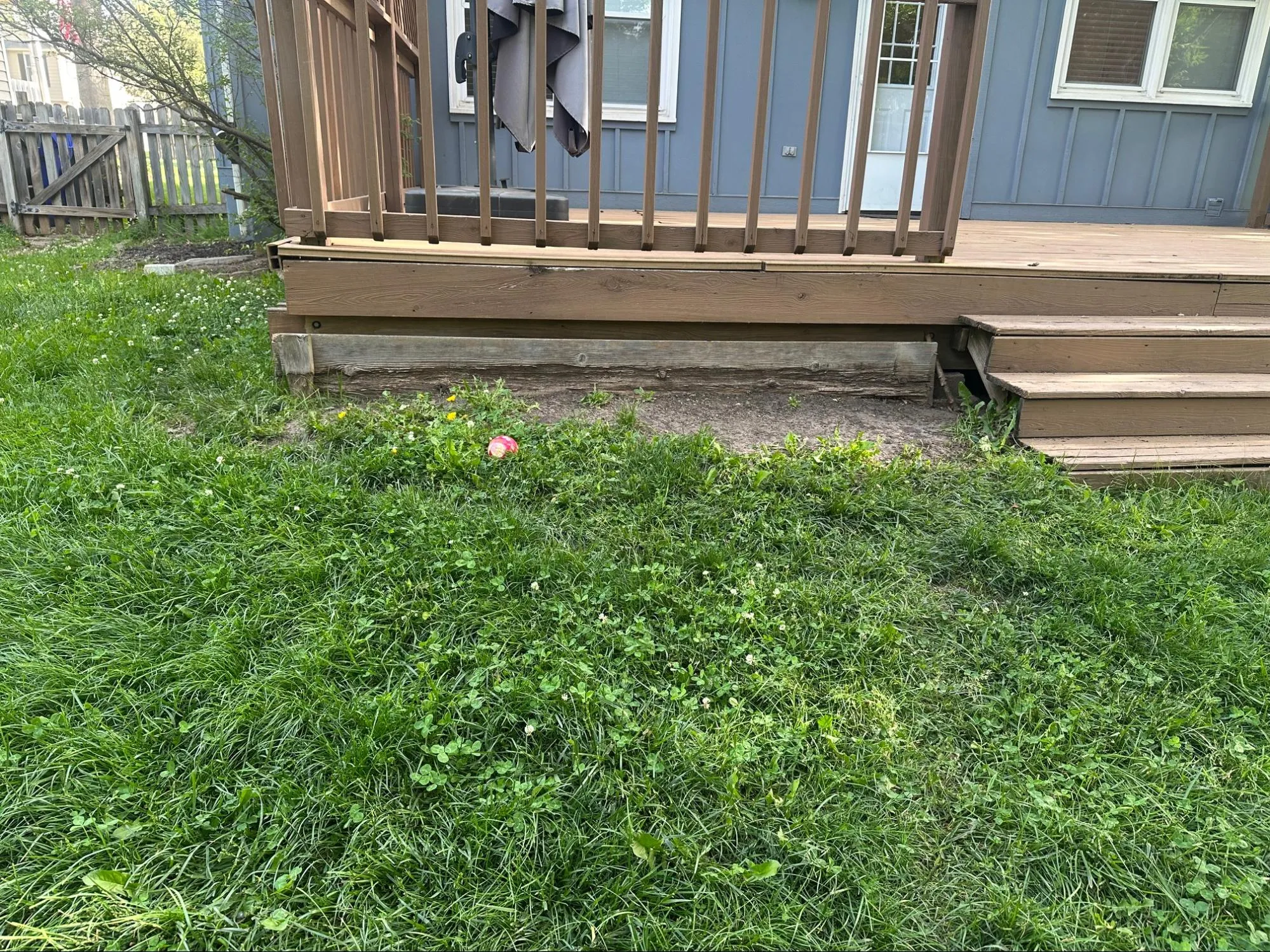 Deck before remodeling showing deteriorated wood