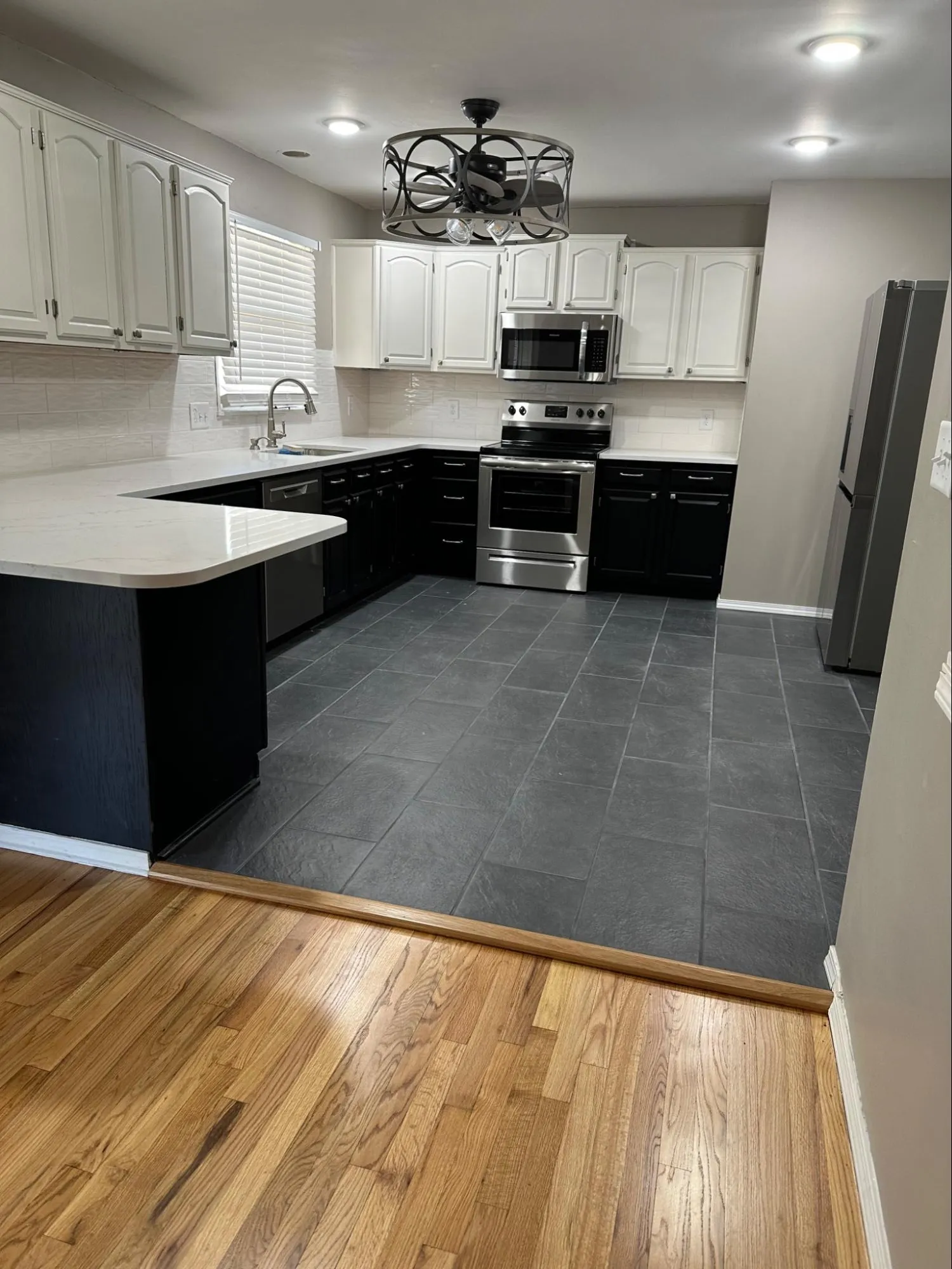 Finished kitchen remodel with stainless steel appliance installation, cabinet craftsmanship, and updated fixtures