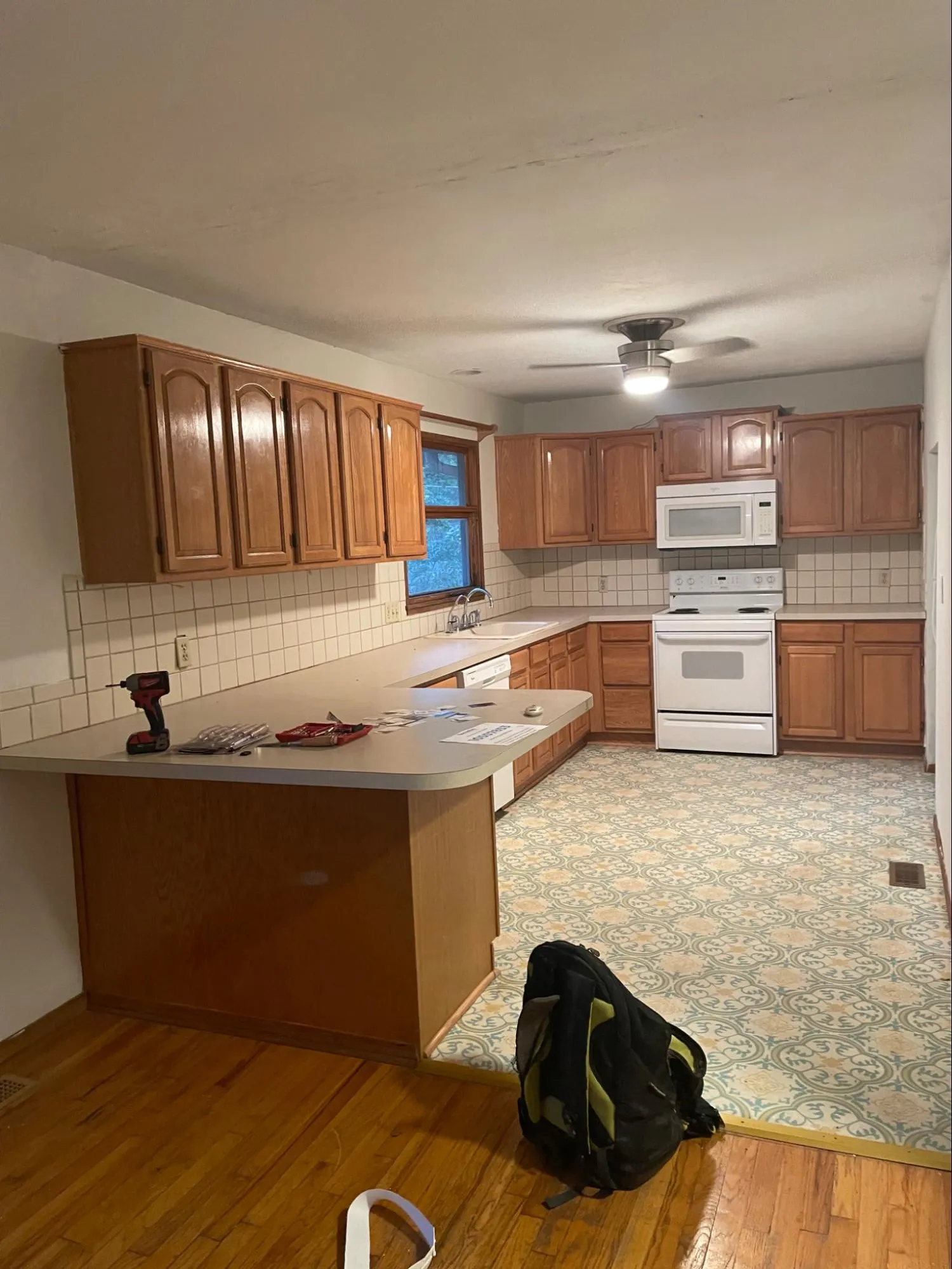 Residential kitchen before remodeling showing aged wood cabinetry and deteriorated fixtures