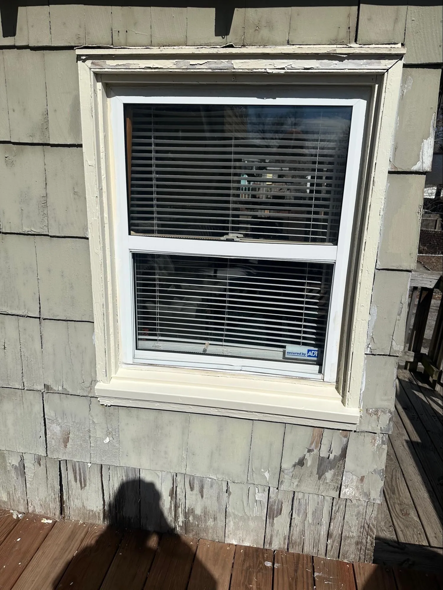 Exterior home before siding repair showing wood rot damage