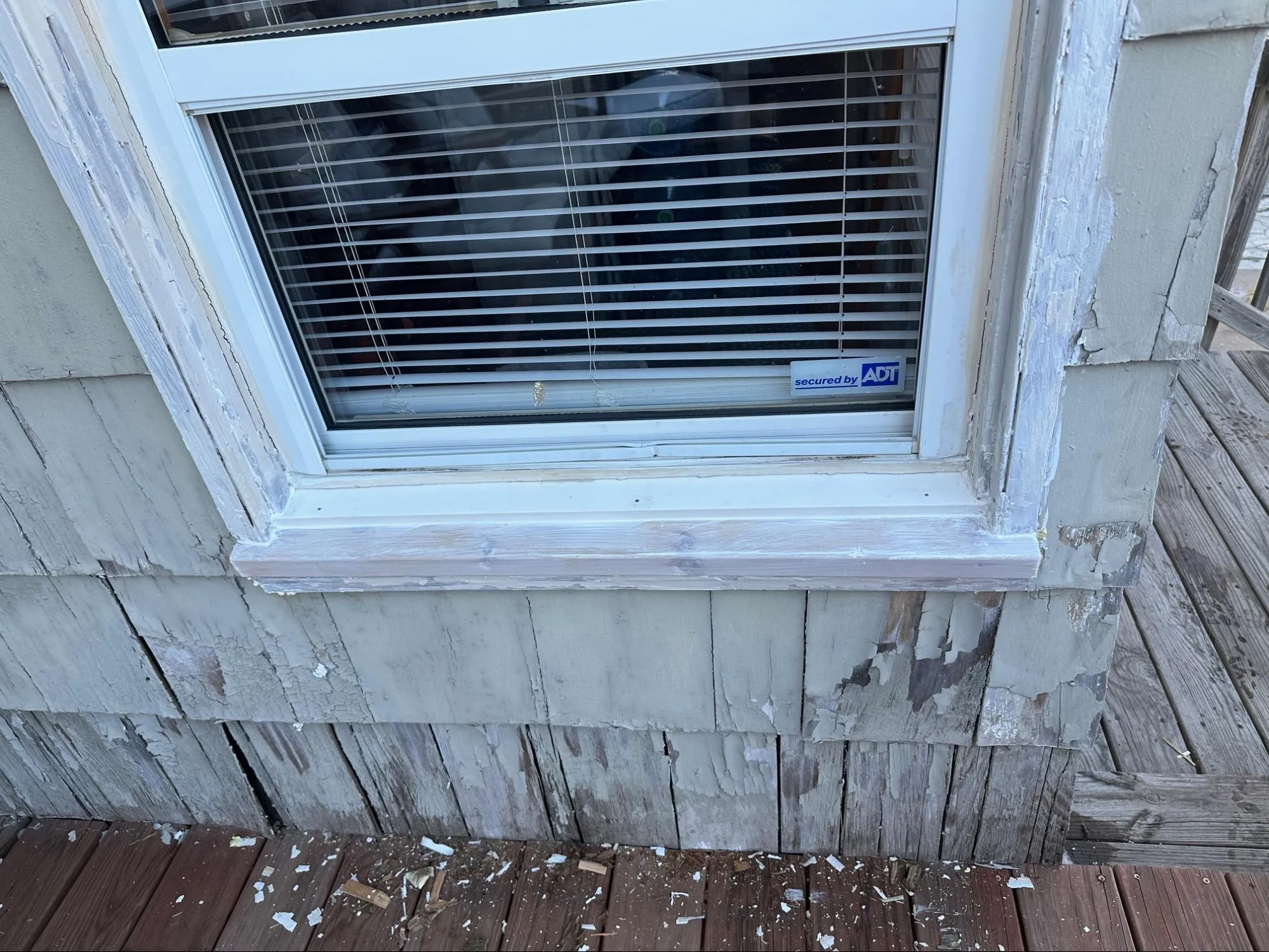 Property exterior before siding installation showing wood rot