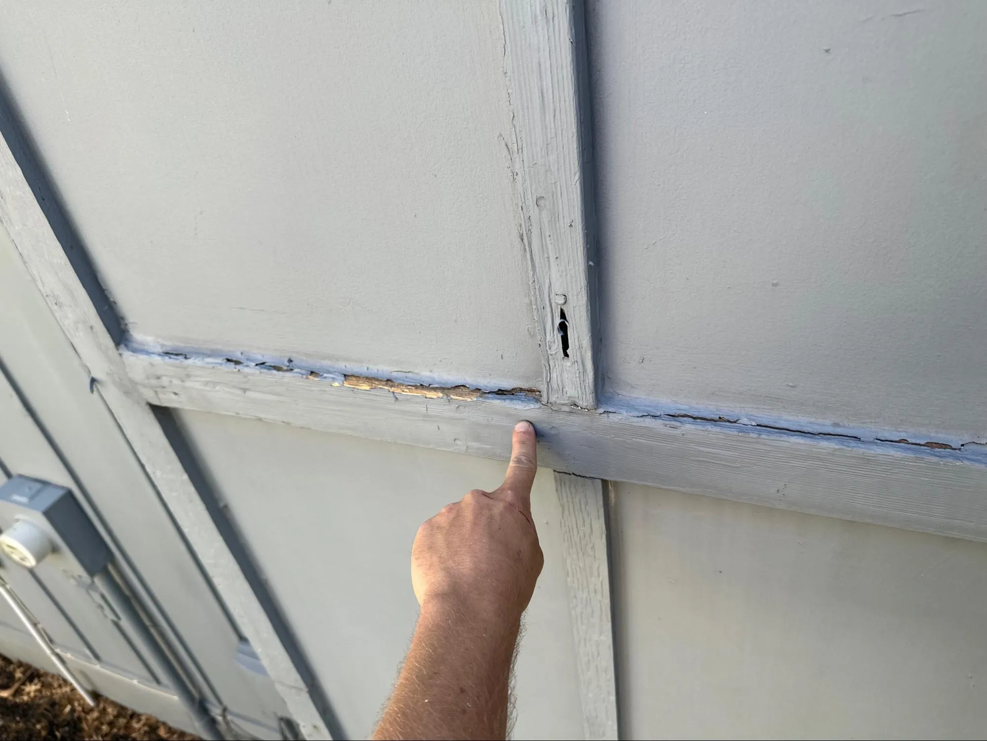 Residential siding before repair with wood rot damage