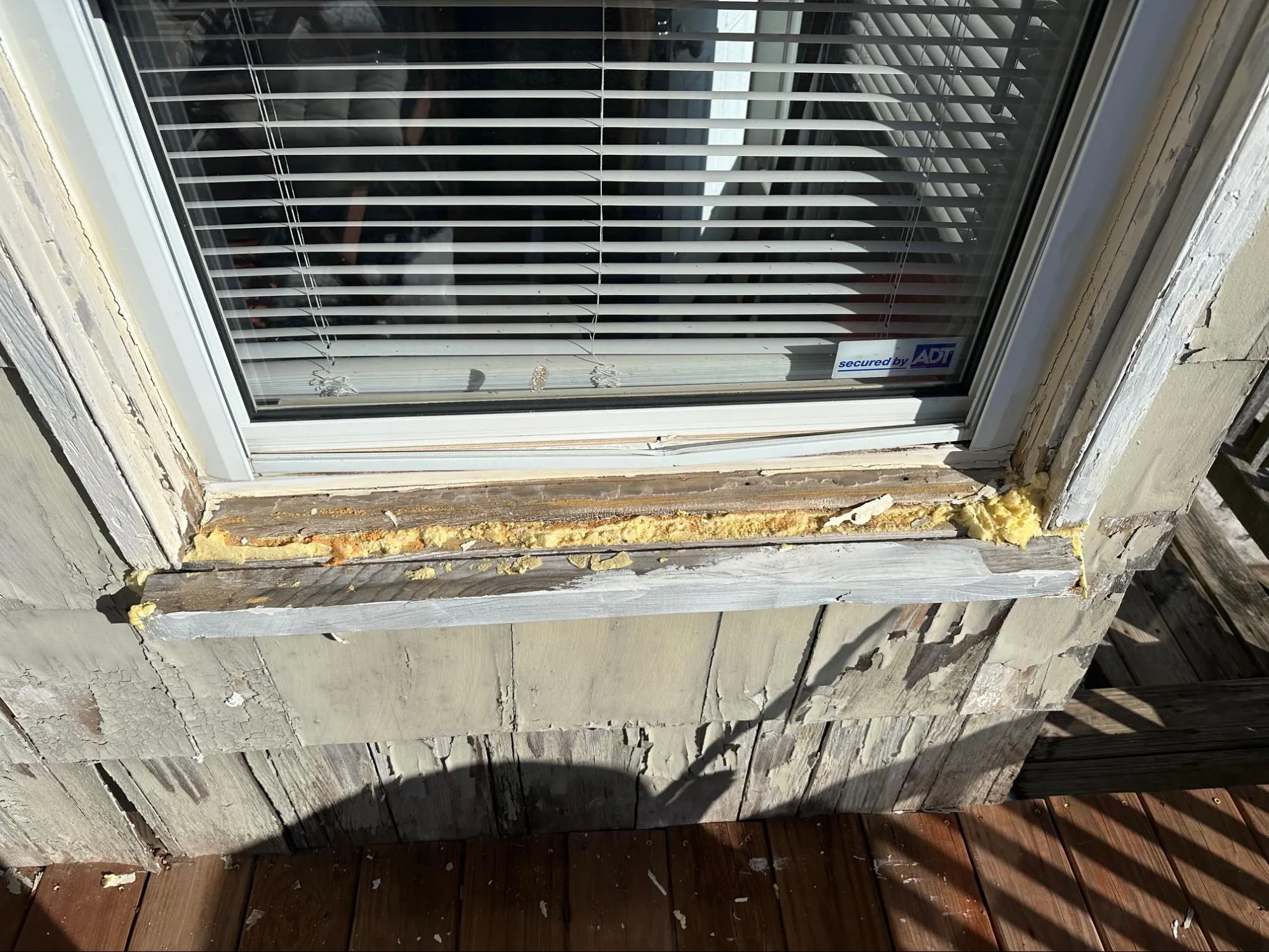 Home exterior before siding project showing aged siding